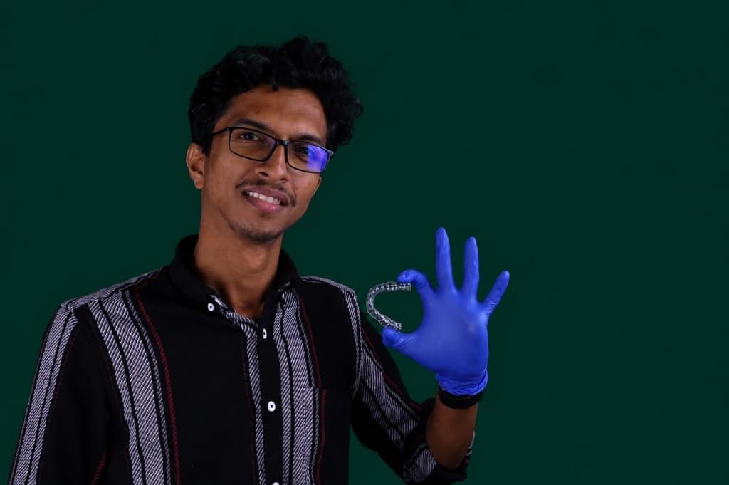 Royaldent specialist holding clear aligner orthodontic tray